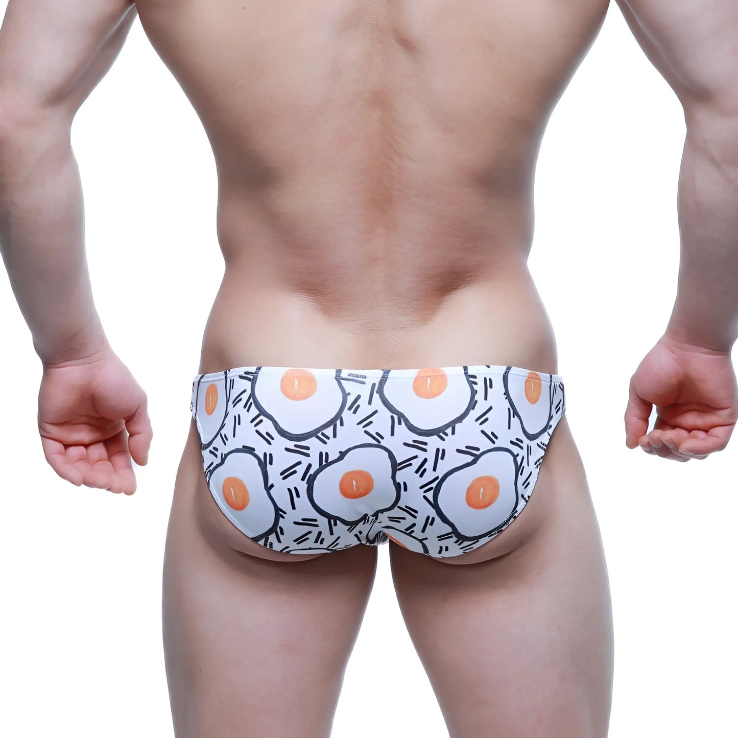 White swim trunks by MetroMaleWear with cartoon fried egg pattern and black line accents lowrise bikini 6115-67