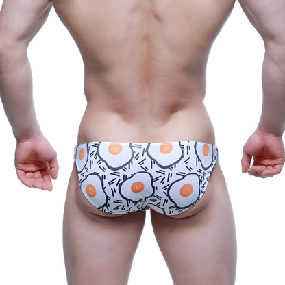White swim trunks by MetroMaleWear with cartoon fried egg pattern and black line accents lowrise bikini 6115-67