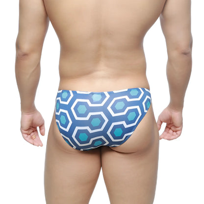 Blue and white geometric-patterned swim trunks with retro hexagonal design from MetroMaleWear super lowrise bikini line