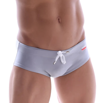 Light gray MetroMaleWear swim briefs with white drawstring and red brand tag on the waistband for comfortable swim use