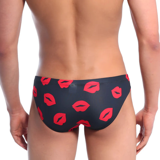 Black swim trunks by MetroMaleWear Vasco hip brief featuring bold red lipstick print pattern in kiss black color