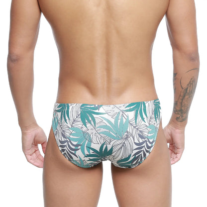 White swim trunks metro malewear meadow bikini 5103-56 with vibrant teal and dark gray tropical leaf pattern