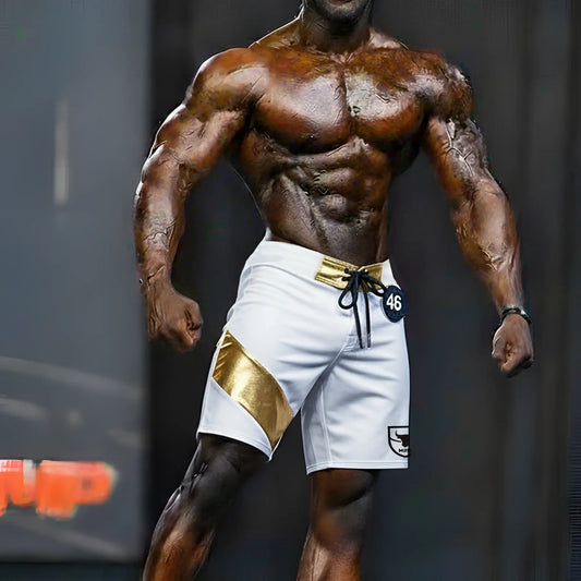White MetroMaleWear Physique board shorts with gold diagonal stripe, gold belt loop, black drawstring, and logo patch