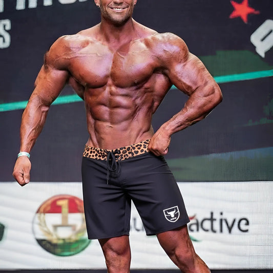 Black athletic shorts metro malewear physique board short with leopard print waistband and white shield logo on left leg