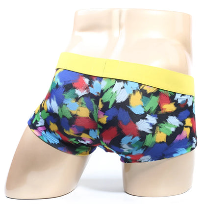 Colorful abstract brushstroke men’s boxer briefs with a bright yellow elastic waistband.