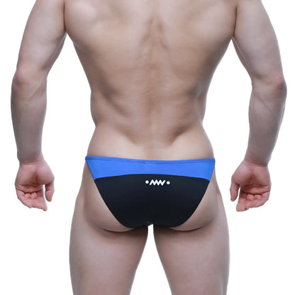 Back view of metro malewear prodigy bikini royal swim trunks in blue and black with a white logo