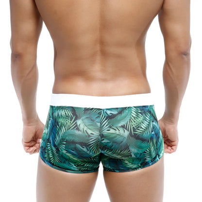Green tropical leaf-patterned swim boxer briefs with white waistband by metromalewear for jungle adventures