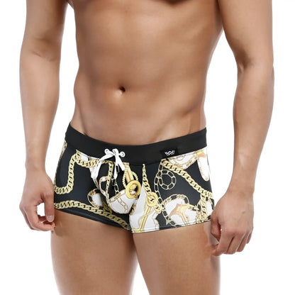 Black MetroMaleWear Profundo swim boxer briefs with bold gold and white chain pattern and contrasting black waistband