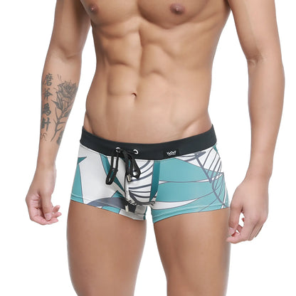 Teal and white tropical leaf-patterned MetroMaleWear Profundo swim boxer briefs with black elastic waistband