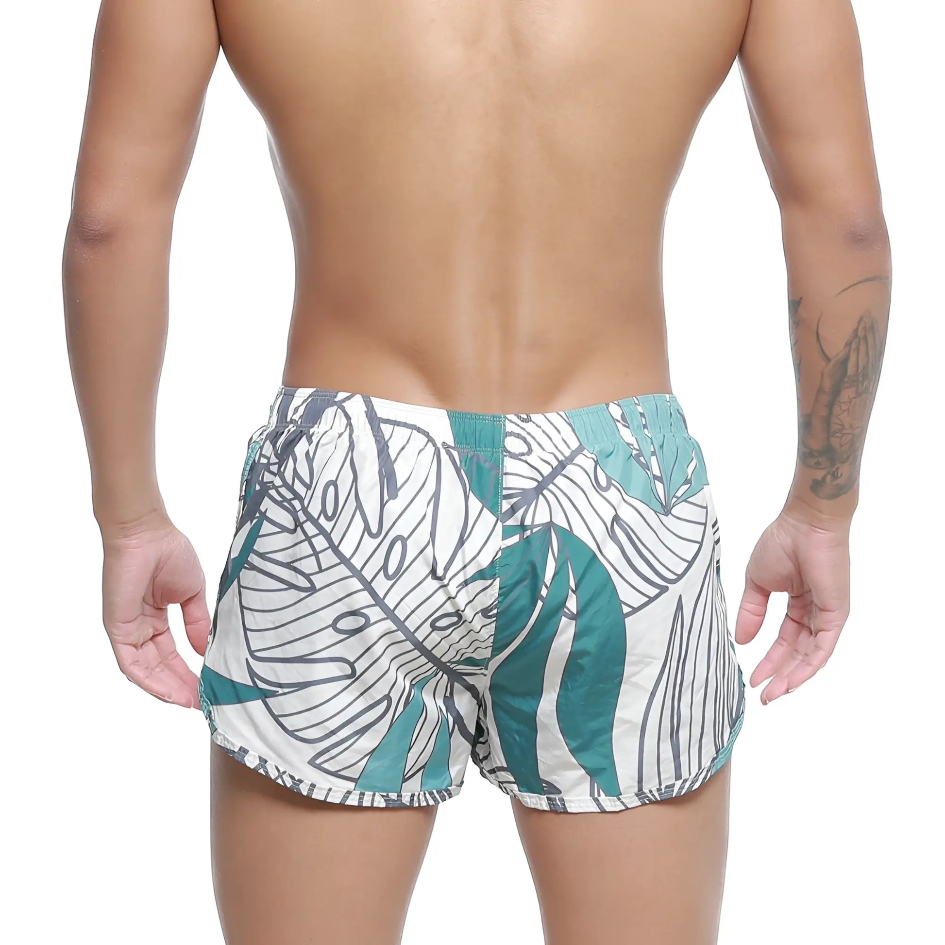 White swim trunks with bold teal and black tropical leaf pattern metroMalewear summer swim shorts meadow 4988-09