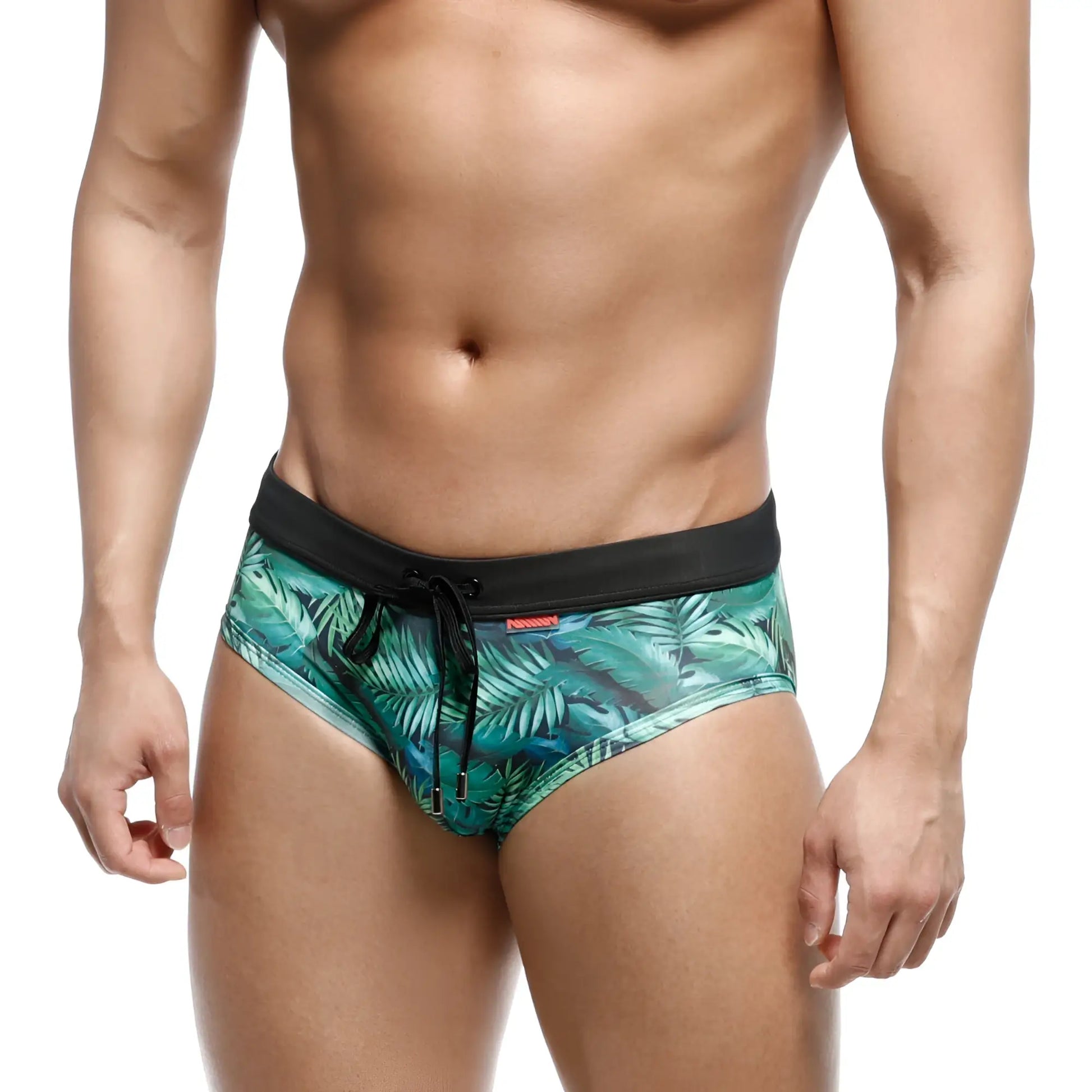Green tropical leaf-patterned swim trunks with black elastic waistband and drawstring from MetroMaleWear