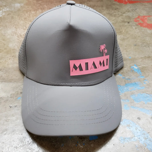Gray miami baseball cap with pink rectangular patch featuring black lettering and palm trees on front