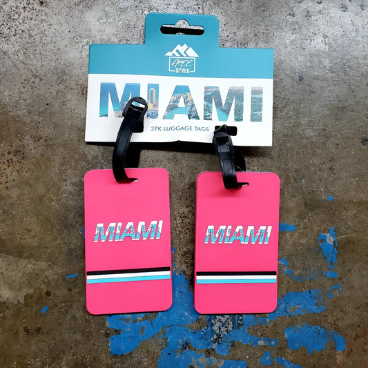Bright pink rectangular miami luggage tags set of 2 with bold white letters and black blue turquoise stripes