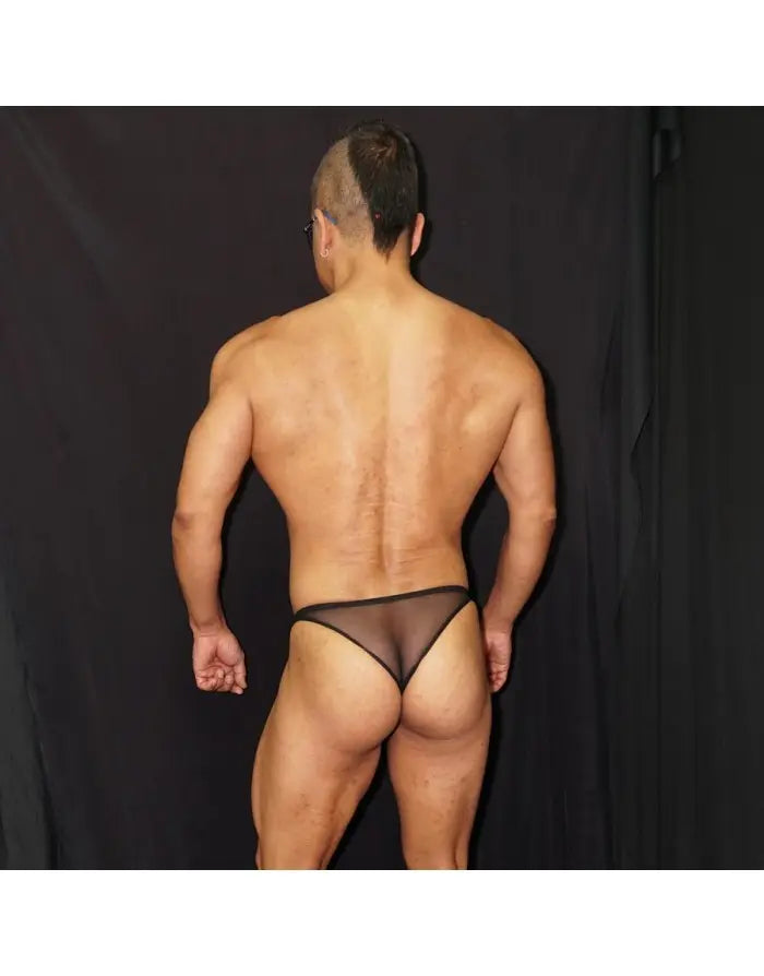Black tulle micro bikini underwear by Arroyman featuring minimal coverage and sheer fabric shown on a model from the back.