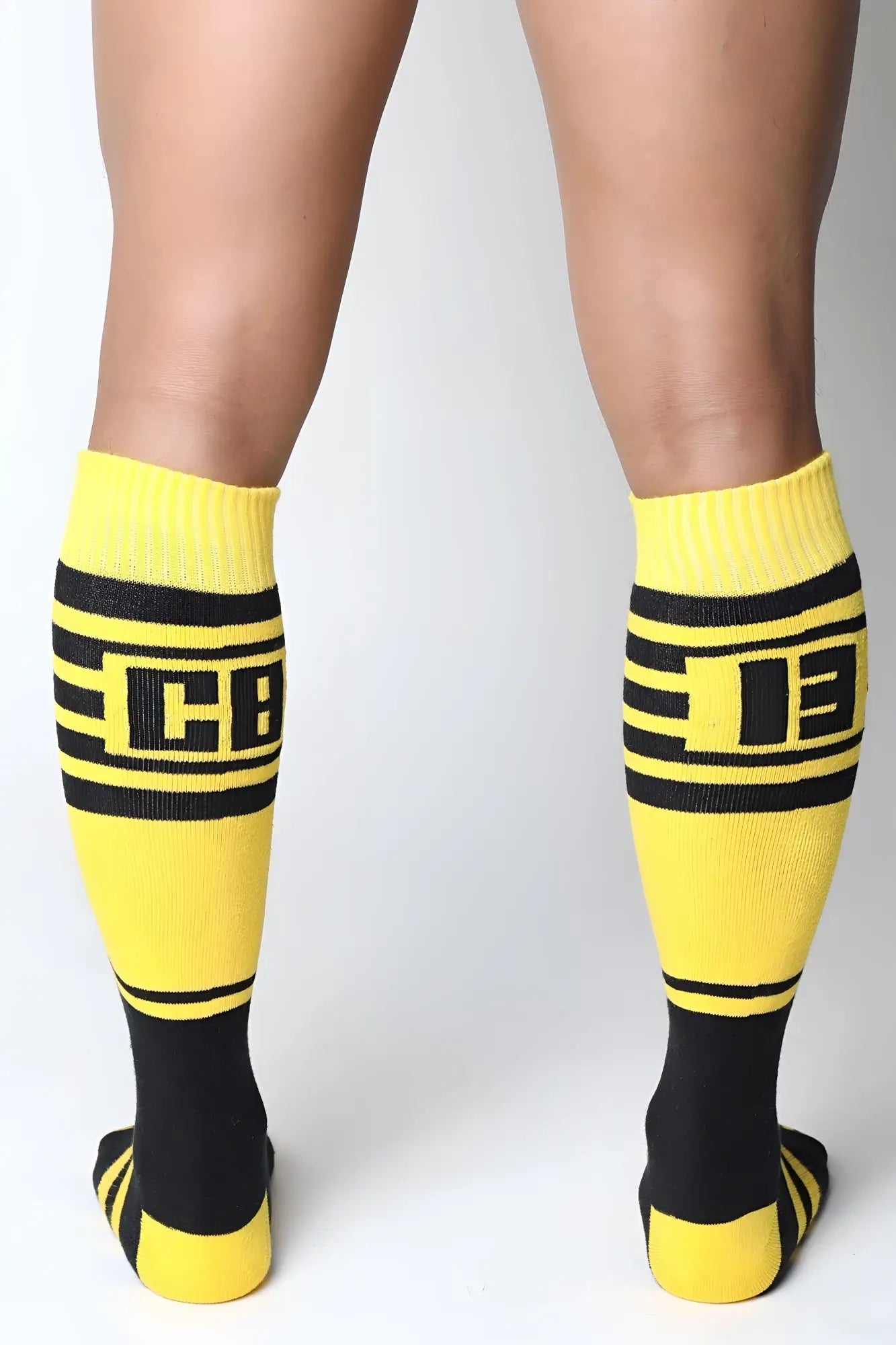 Midfield knee high socks in bright yellow and black with bold stripes and a prominent cb logo in the center