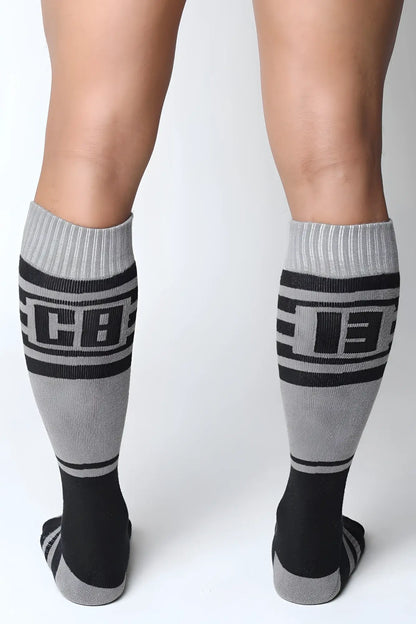 Midfield knee high socks in gray and black with bold cb lettering ribbed cuffs and toe accents