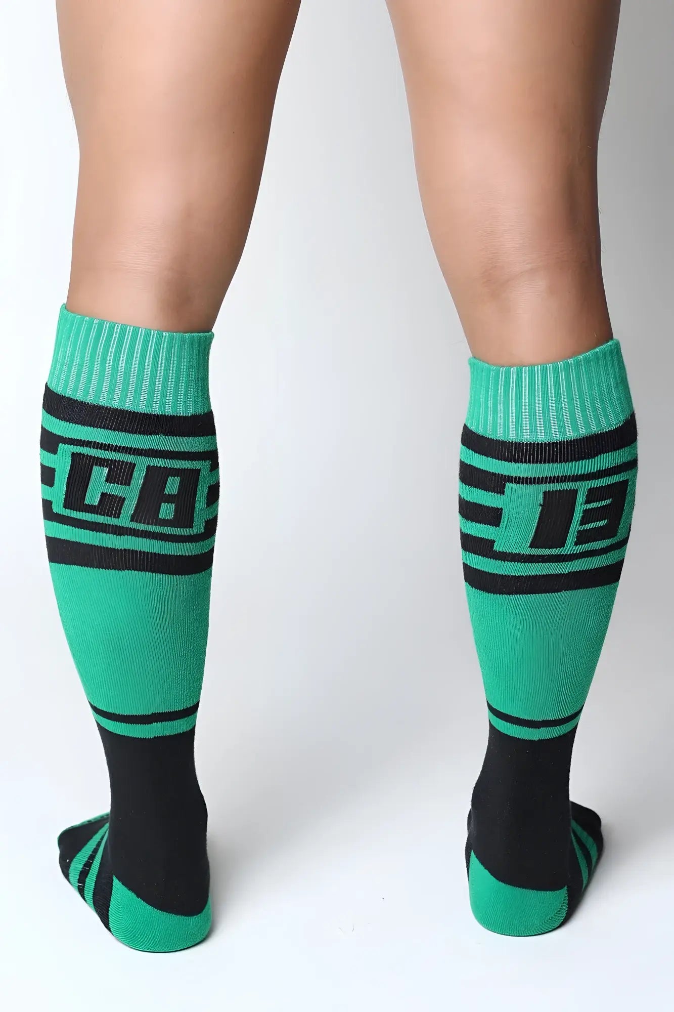 Midfield knee high socks in green and black with bold lettering on the calf designed for athletic use