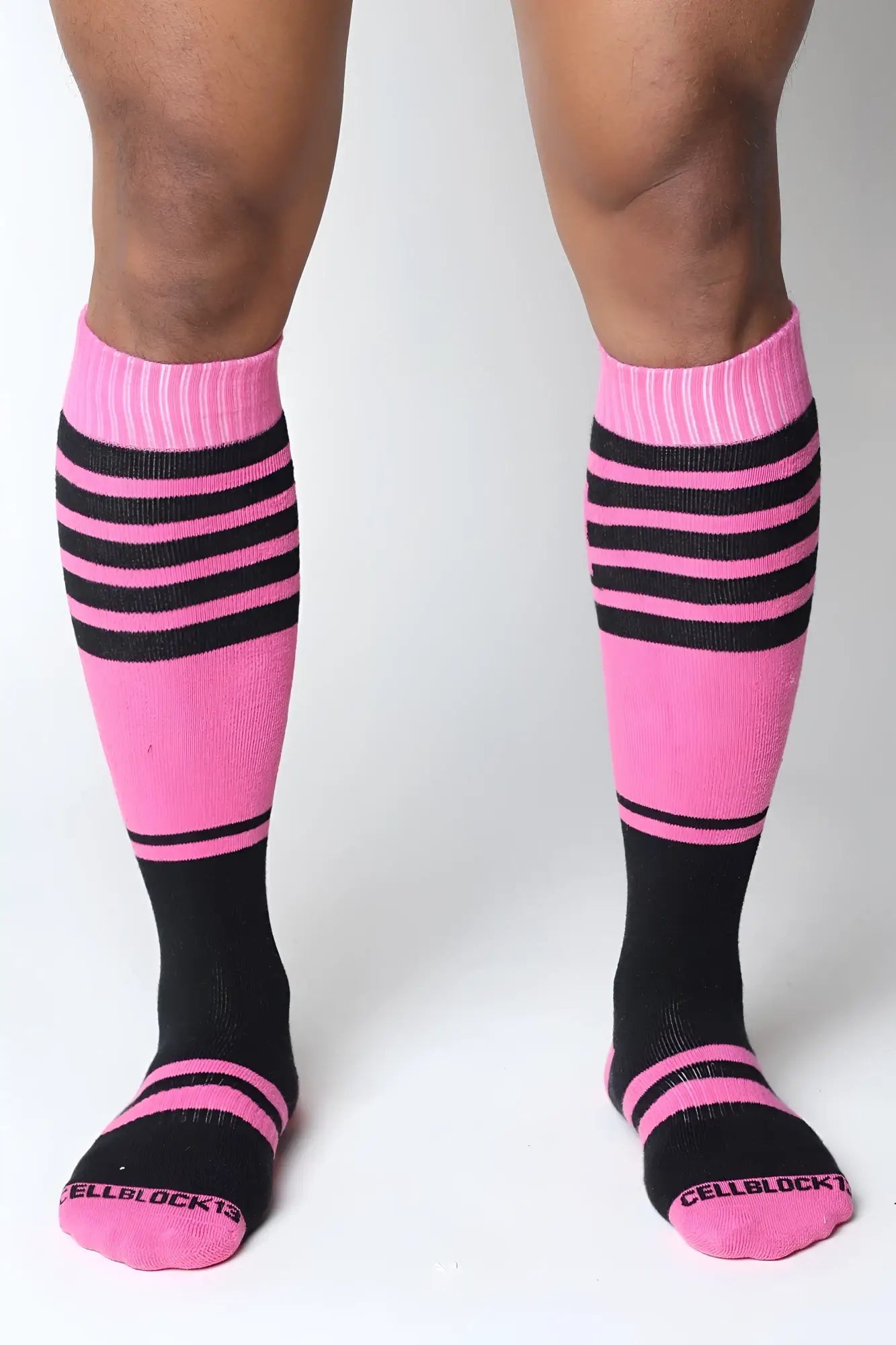 Midfield knee high sock in pink and black stripes with ribbed cuff and cellblock13 logo embroidered on toe