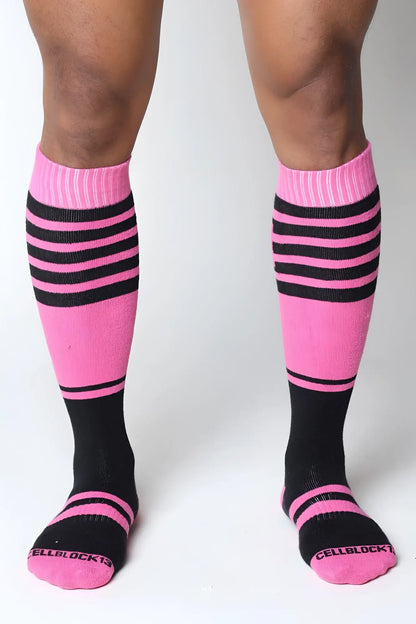 Midfield knee high sock in pink and black stripes with ribbed cuff and cellblock13 logo embroidered on toe