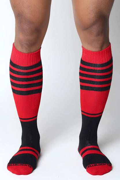 Midfield knee high socks in red and black stripes with ribbed texture and cellblock 13 branding on the toe