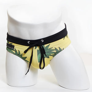 Yellow miiw floral beach bikini swimwear trunks with green leaf pattern and black elastic waistband size s