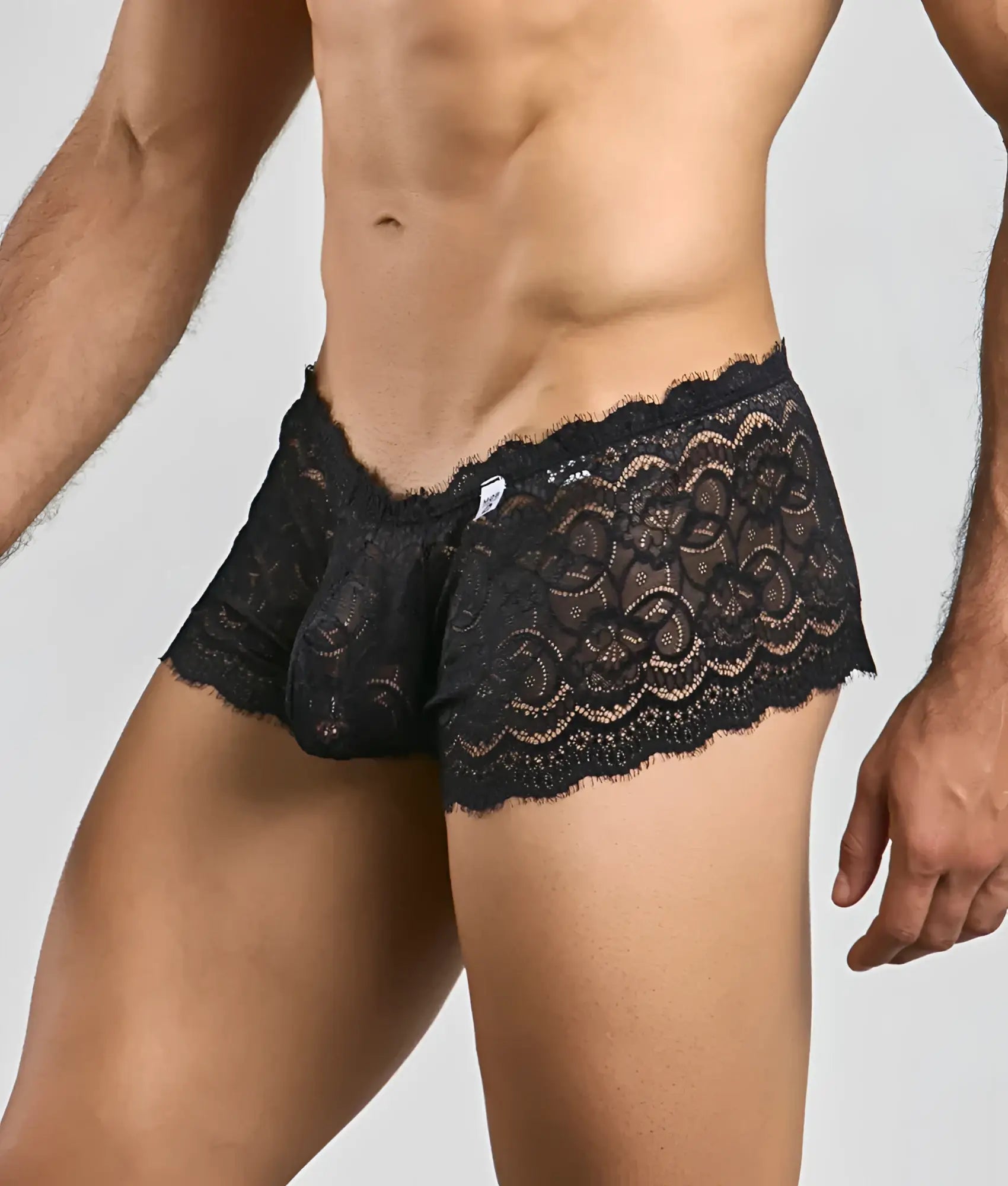 Black lace boxer shorts with intricate floral patterns and scalloped edges in a rose design for men