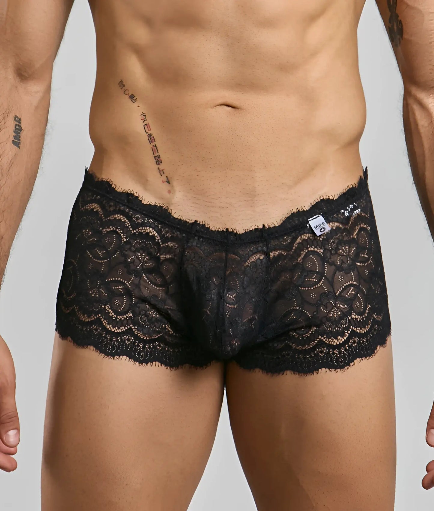 Black lace boxer short rose men’s underwear with intricate floral patterns and delicate frayed hem front view