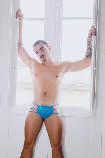 Mob men’s lace pouch thong featuring blue lace-trimmed briefs with subtle pattern and thin side straps
