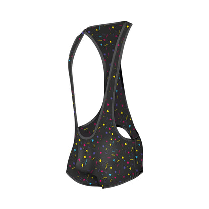Black cycling bib shorts with vibrant multicolored confetti pattern featuring yellow pink blue and purple geometric shapes
