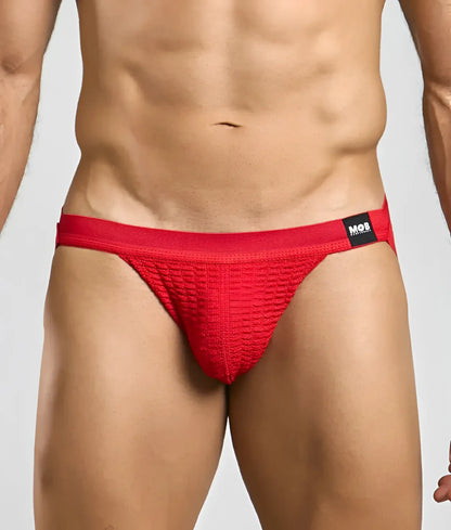 Red textured swim jockstrap briefs with a black mob brand tag on the waistband for swimwear use