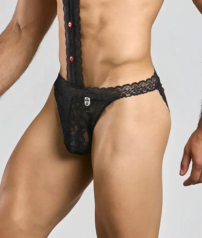 Black lace men’s thong underwear with red buttons and a MOB branded tag in a tuxedo lace design