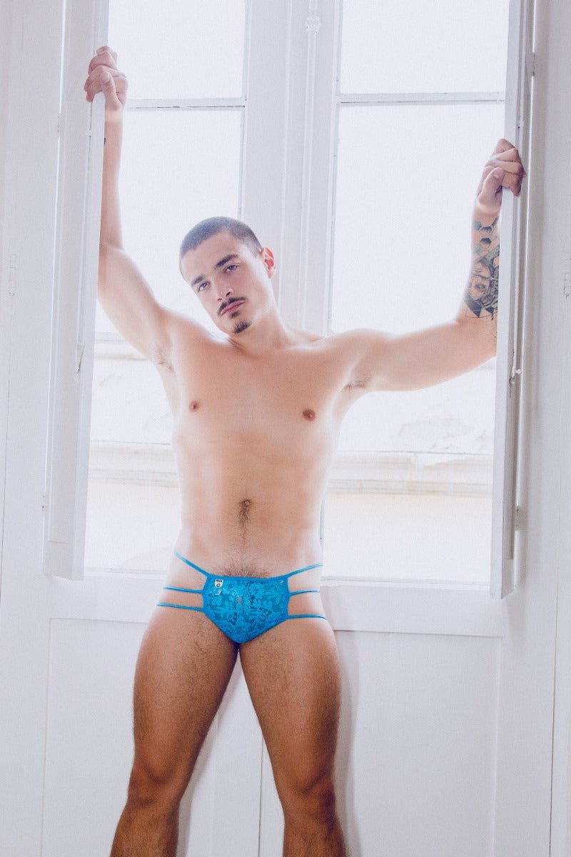 Mob men’s lace pouch thong featuring blue lace-trimmed briefs with subtle pattern and thin side straps