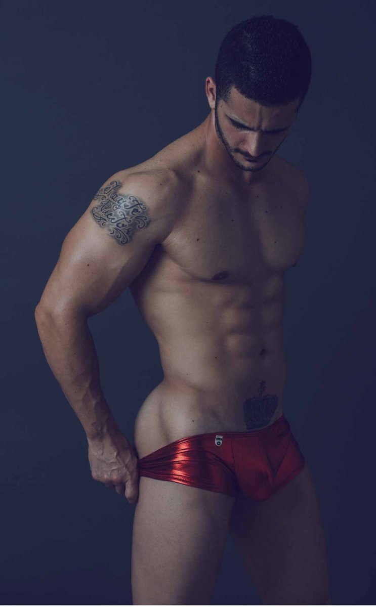 Shiny red metallic mob mirror boxer briefs with a small logo on the front in close-up view
