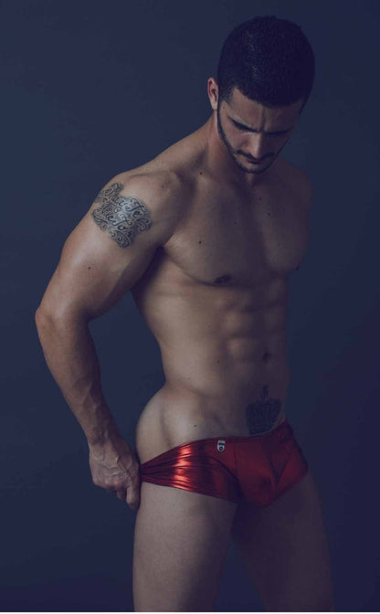 Shiny red metallic mob mirror boxer briefs with a small logo on the front in close-up view