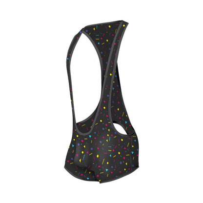 Black cycling bib shorts with vibrant multicolored confetti pattern featuring yellow pink blue and purple geometric shapes