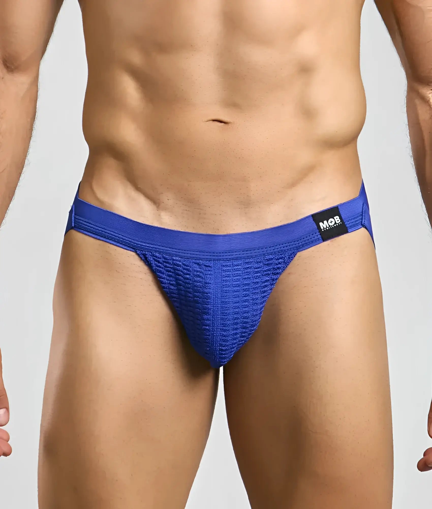 Blue textured athletic swim jockstrap briefs with black mob brand tag on waistband for active use