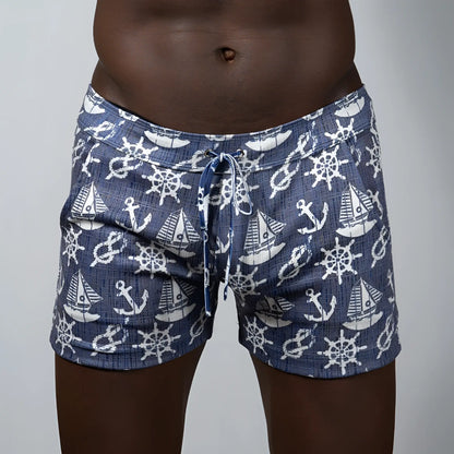 Navy blue nautical linen texture shorts with white anchor sailboat and ship wheel pattern swim trunks