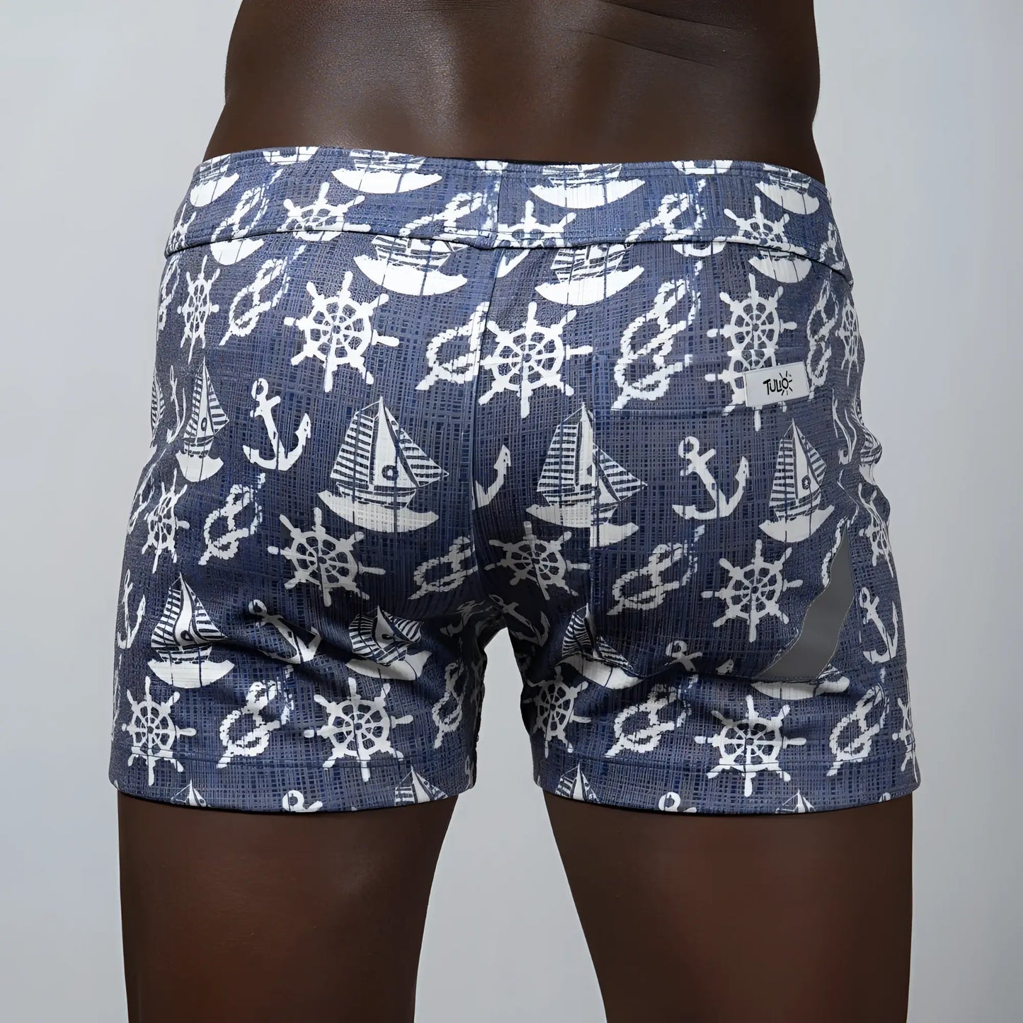Nautical linen texture shorts in blue featuring white ship wheels anchors and sailboats pattern