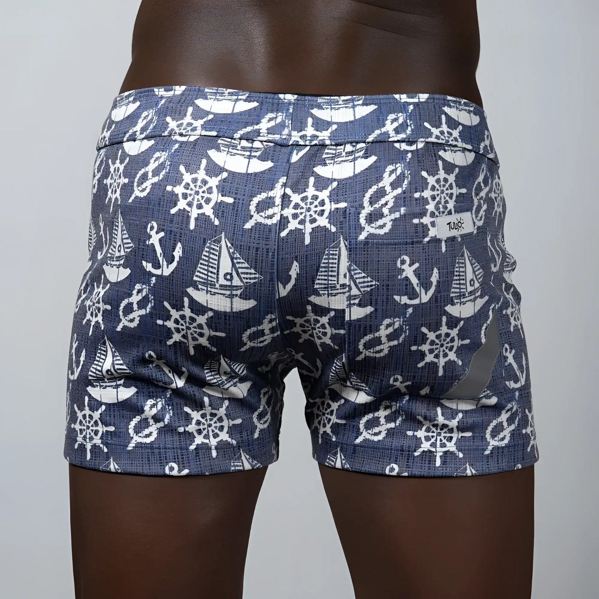 Nautical linen texture shorts in blue featuring white ship wheels anchors and sailboats pattern