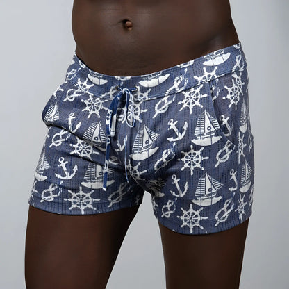 Nautical linen texture shorts in navy blue linen fabric with white anchors and ship wheels and an elastic waistband