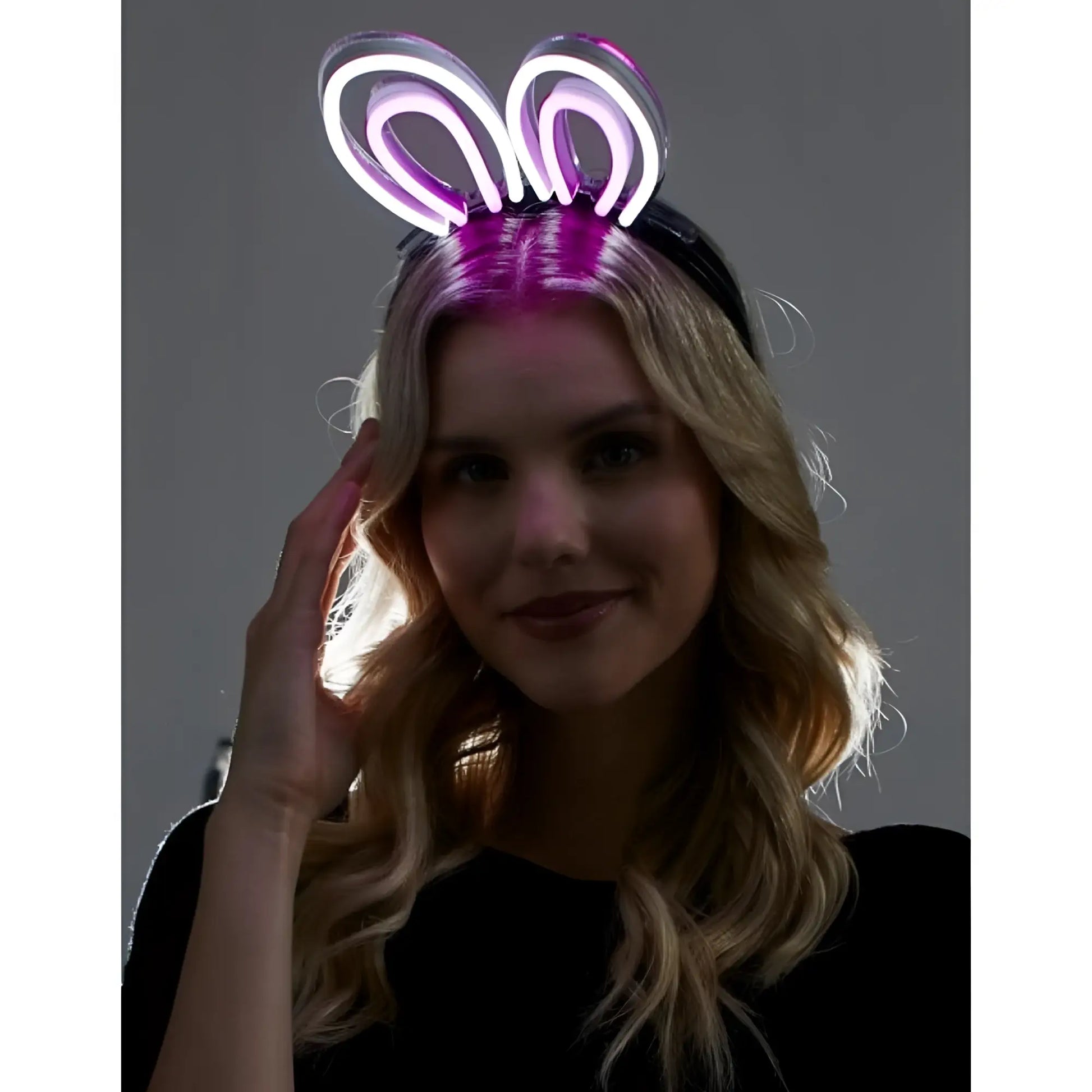Purple neon bunny ears headband glowing with bright light for festive and party wear accessory