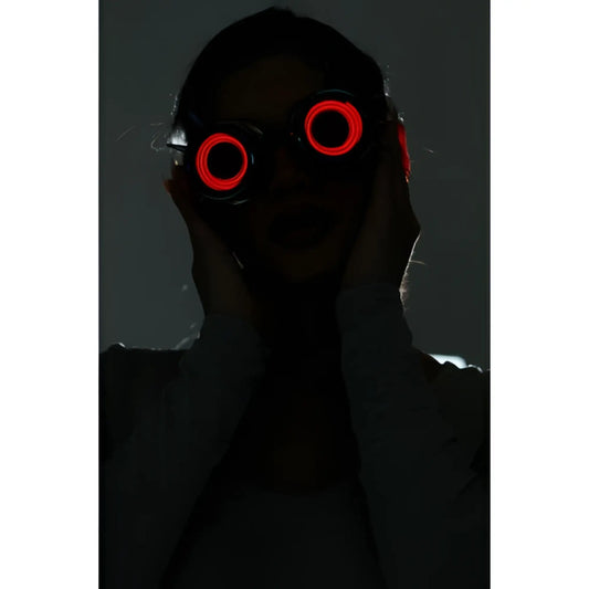 Neon light up goggles featuring red led-lit circular glowing lenses for vibrant nighttime use