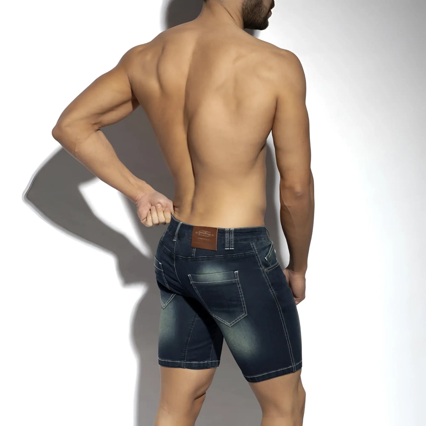 Dark blue denim bermuda jeans shorts with faded wash and stitched pockets showing the back side