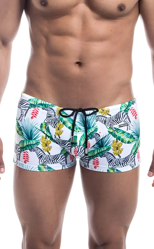 White swim trunks oceanico square cut with vibrant tropical zebra pattern green palm leaves red flowers and black waistband