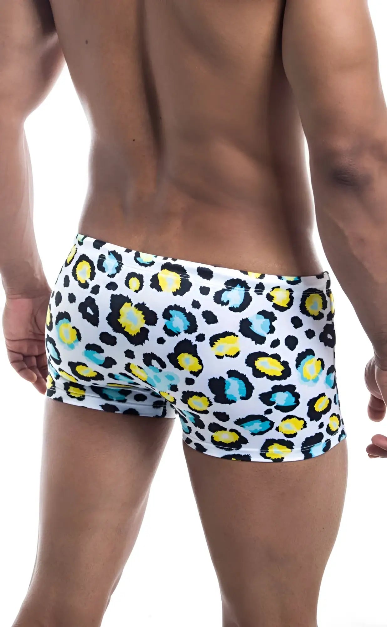 Oceanico square cut white swim trunks with bold leopard print featuring yellow and teal spots