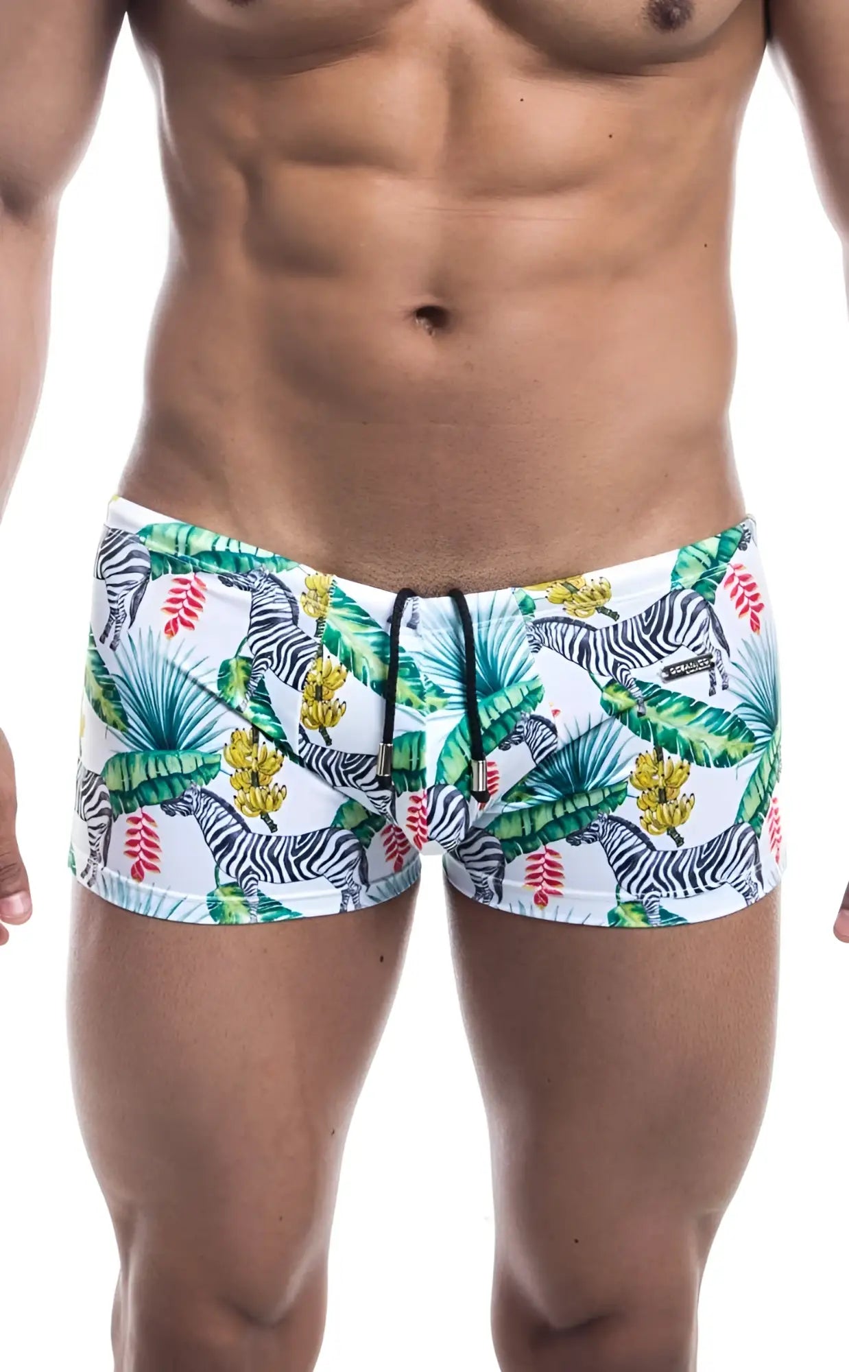 White oceanico square cut swim trunks with vibrant tropical pattern of black and white zebras green palm leaves and yellow flowers