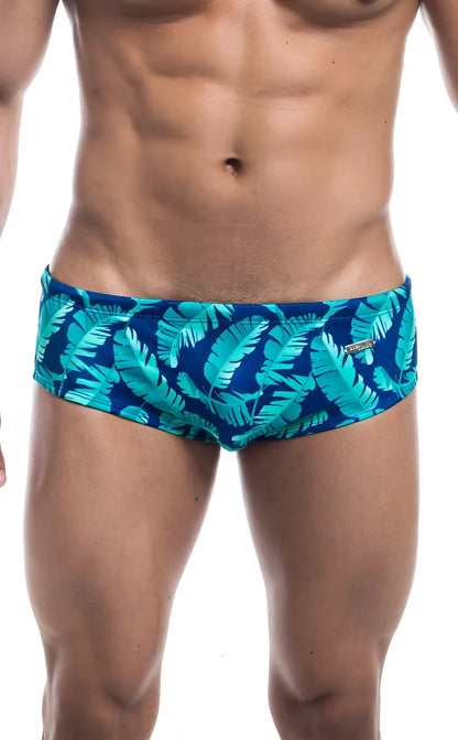 Oceanico swim brief blue swim trunks with vibrant turquoise tropical leaf pattern for beach and pool use