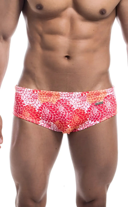 Oceanico swim brief with vibrant floral pattern in pink red and orange on white base ideal for beachwear