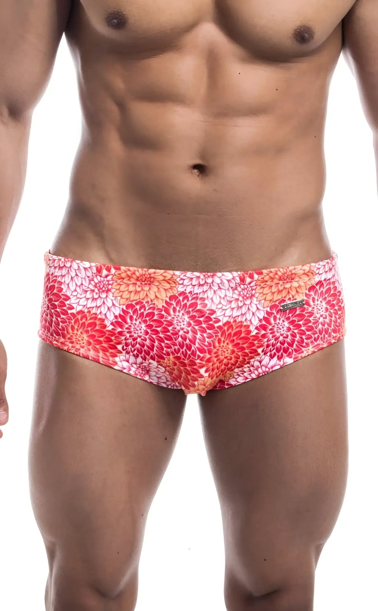 Oceanico swim brief with vibrant pink red and orange floral pattern on white base made for swimming and beachwear