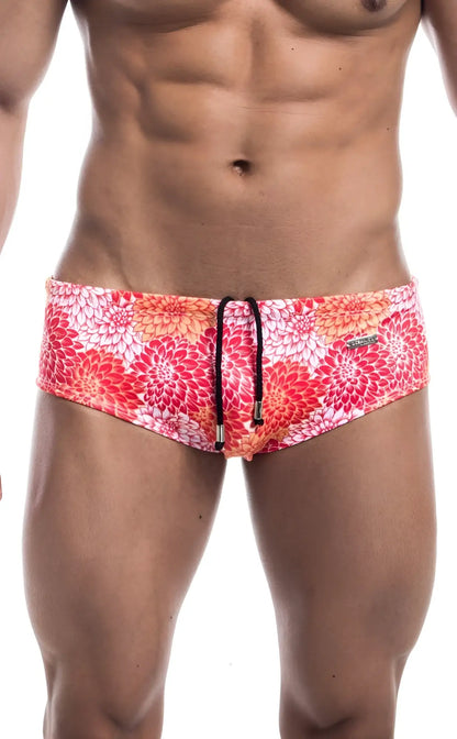 Oceanico swim brief featuring vibrant red and pink floral patterned fabric with black drawstring ties
